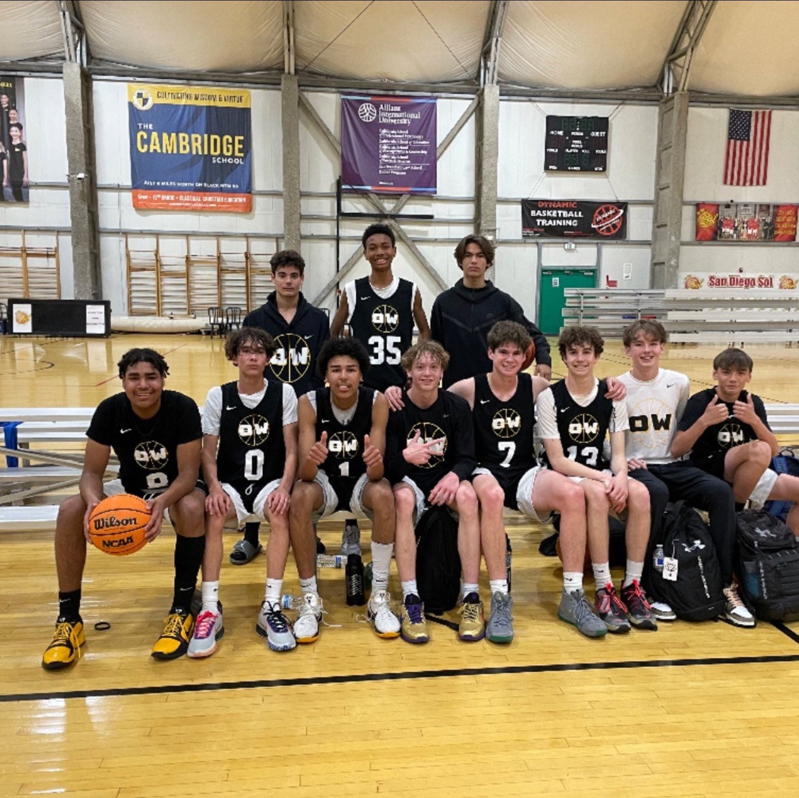 OW players posed for a team photo on the bleachers in a gym